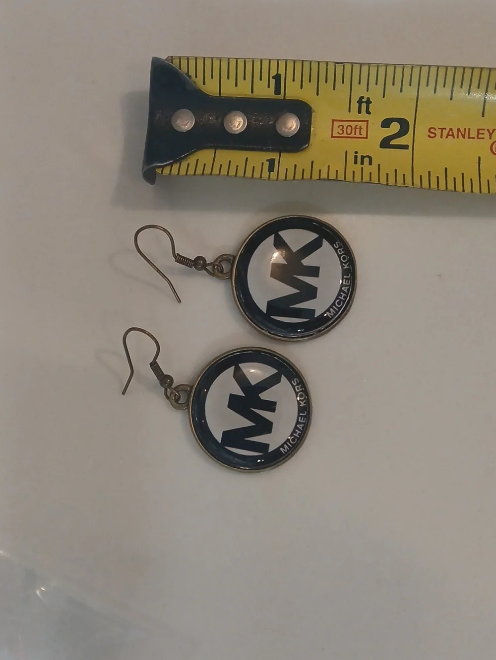 Michael Kors round logo dangle earrings feature the brand's iconic 